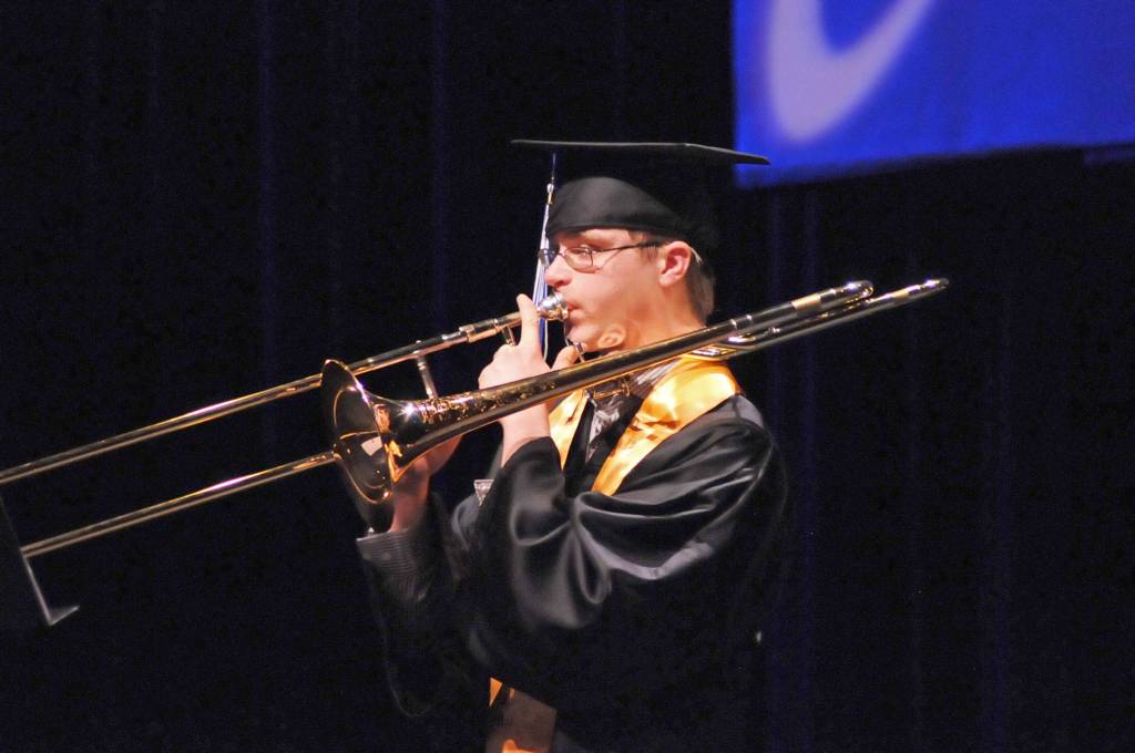 Connections Homeschool graduate Eli Stoll plays the trombone during a student performance at the program&rsquo;s graduation ceremony on Thursday, May 24, 2018 in Soldotna, Alaska. The program, administered by the Kenai Peninsula Borough School District, graduated 58 students this year. (Photo by Elizabeth Earl/Peninsula Clarion)