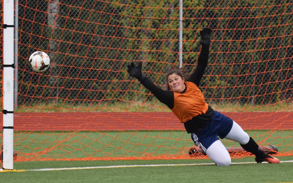 Soldotna goalie Maddie Kindred misses a penalty kick from Grace&rsquo;s Maddy Morgan Friday in a Division II state tournament semifinal at Eagle River High School. (Photo by Joey Klecka/Peninsula Clarion)