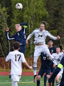 Homer&rsquo;s Charles Rohr (left) and Kenai&rsquo;s Luke Beiser (24) go up for a header Friday in a Division II state tournament semifinal at Service High School. (Photo by Joey Klecka/Peninsula Clarion)