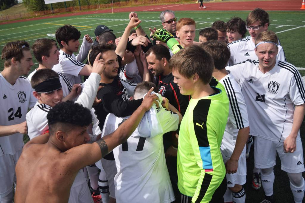 The Kenai Central boys celebrate after beating Juneau-Douglas 3-0 to win the Division II state soccer championship Saturday afternoon at Service High School. (Photo by Joey Klecka/Peninsula Clarion)