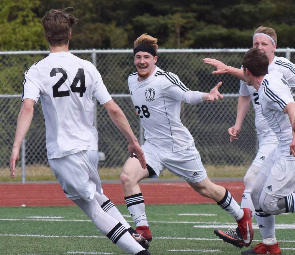 Kenai&rsquo;s Rykker Riddall (28) celebrates with teammates after scoring a goal against Juneau-Douglas in the Division II state soccer championship final Saturday afternoon at Service High School. (Photo by Joey Klecka/Peninsula Clarion)