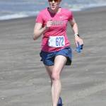 Laura Carpenter of Anchorage runs to victory in the three-mile women&rsquo;s race at the Mouth to Mouth Wild Run and Ride on Monday, May 28, 2018, at the Kenai beach. (Photo by Jeff Helminiak/Peninsula Clarion)