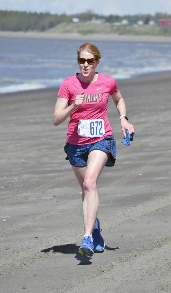 Laura Carpenter of Anchorage runs to victory in the three-mile women&rsquo;s race at the Mouth to Mouth Wild Run and Ride on Monday, May 28, 2018, at the Kenai beach. (Photo by Jeff Helminiak/Peninsula Clarion)