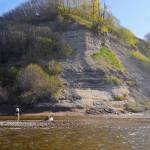 An angler tosses a line in the water near the mouth of Deep Creek on Sunday, May 28, 2018 in Ninilchik, Alaska. Despite the perfect weather and holiday weekend, few anglers dotted the banks of the Ninlichik River and Deep Creek on Sunday, in part because the number of salmon in the rivers so far is still fairly paltry. The Alaska Department of Fish and Game classified the fishing over Memorial Day weekend as poor, in part because the water temperatures are still chilly for this time of year. (Photo by Elizabeth Earl/Peninsula Clarion)