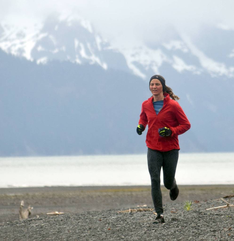 Mariah Johnson runs down the beach during the Dixon/Holden Memorial Tonsina Beach Trail Run on Wednesday in Seward. (Photo by Jeff Helminiak/Peninsula Clarion)