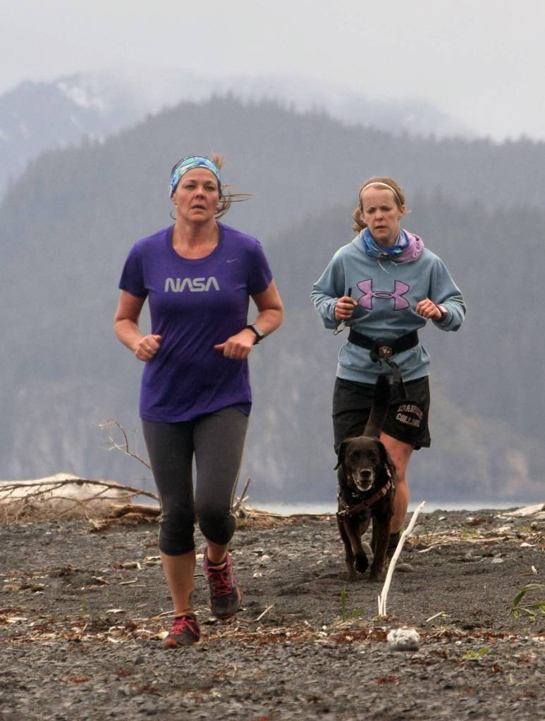 Jennifer Dougherty and Stephanie Wright run in the Dixon/Holden Memorial Tonsina Beach Trail Run on Wednesday in Seward. (Photo by Jeff Helminiak/Peninsula Clarion)