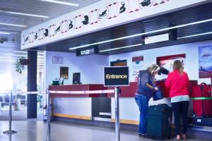 Travelers check baggage with airline Ravn Alaska at the Kenai Muncipal Airport on Thursday, May 31, 2018. Kenai&rsquo;s city government is seeking to raise rents that Ravn and the Kenai airport&rsquo;s other airline, Grant Aviation, pay for terminal space such as their ticket counters. (Ben Boettger/Peninsula Clarion)