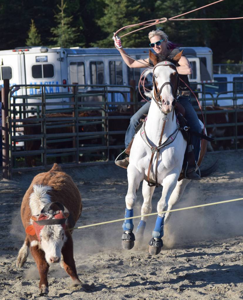Corey Wilkinson lassoes a cow Friday during events at the PCRS Rodeo at the Soldotna Rodeo Grounds. (Photo by Joey Klecka/Peninsula Clarion)
