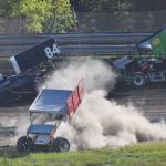 Elton McGahan goes off road in his sprint car as fellow racers Jimmie Hale (84) and Geoff Clark (3) make their way by Saturday night at Twin City Raceway in Kenai. (Photo by Joey Klecka/Peninsula Clarion)