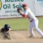 Oilers shortstop Paul Kunst forces out JC Correa of the Anchorage Bucs but throws late to first for the double play Thursday, June 7, 2018, at Coral Seymour Memorial Park in Kenai. (Photo by Jeff Helminiak/Peninsula Clarion)