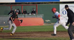Anchorage Bucs third baseman Dimitri Colacchio (left) fields a groundball while the Oilers&rsquo; Ryan Koch sprints to third Friday evening at Coral Seymour Memorial Ballpark in Kenai. (Photo by Joey Klecka/Peninsula Clarion)