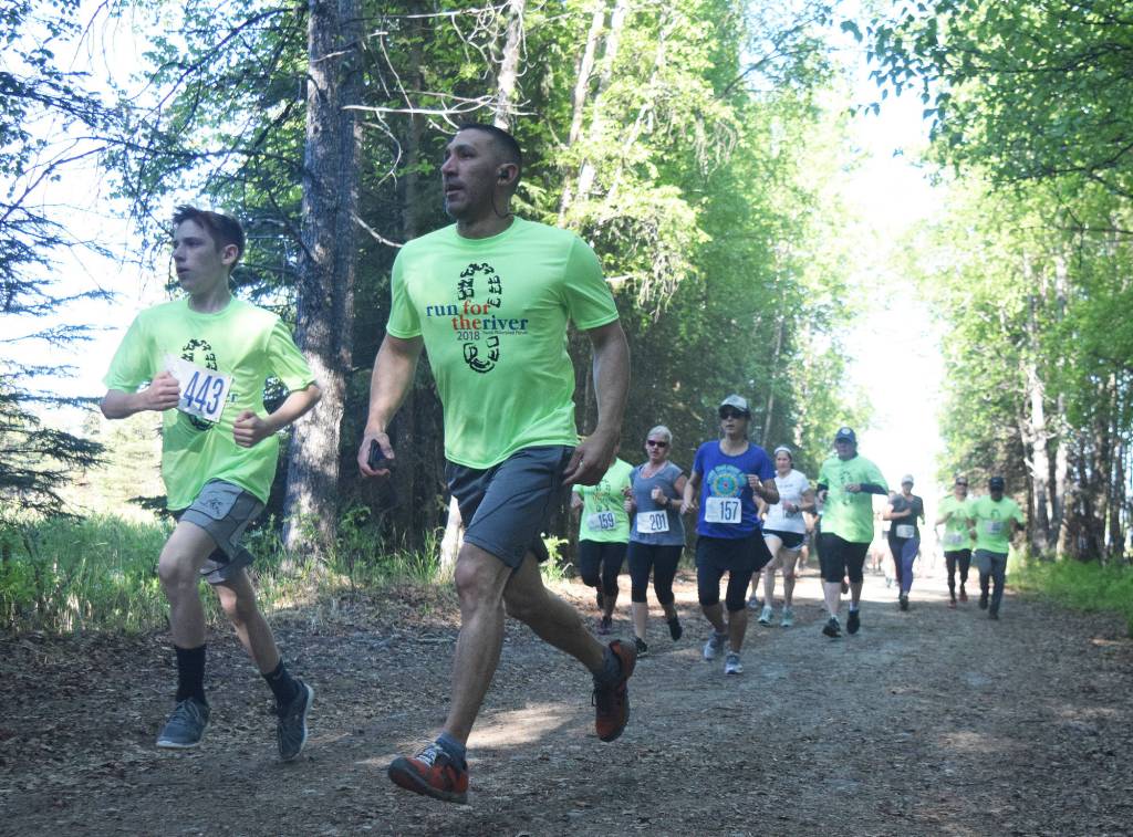 Joshua Salinas (443) leads a pack of runners Saturday morning at the Run for the River 5K/10-mile races near Soldotna Creek Park. (Photo by Joey Klecka/Peninsula Clarion)