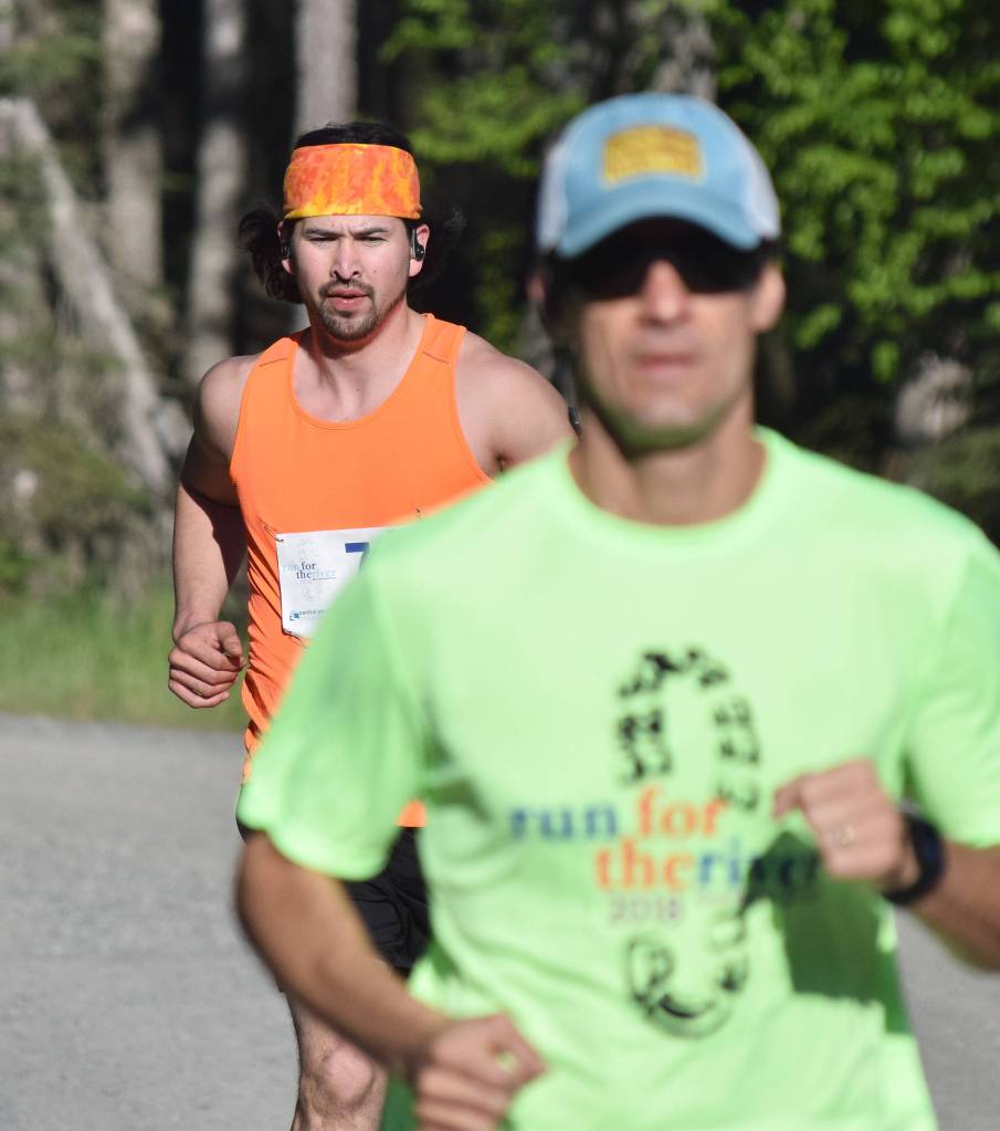 David Lambert (background) chases Benjamin McGarry early Saturday morning at the Run for the River 5K/10-mile races near Soldotna Creek Park. (Photo by Joey Klecka/Peninsula Clarion)