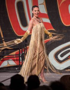 Former Miss Alaska USA Alyssa London displays designers Jason Brown and Donna Decontie-Brown&rsquo;s work at the Native Fashion Show at Centennial Hall on Friday, June 8, 2018. (Michael Penn | Juneau Empire)