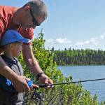Thomas and his son Emil, visiting from Austria, try casting a line into Arc Lake on Wednesday, June 13, 2018 in Soldotna, Alaska. King salmon fishing is restricted on all the streams on the western Kenai Peninsula due to weak returns, but lake fishing and early-run sockeye fishing at the confluence of the Russian and Kenai Rivers is still available to anglers hungry to fish. (Photo by Elizabeth Earl/Peninsula Clarion)