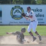 Kenai Twins shortstop Austin Asp attempts to relay a double play ball to first base while Chugiak&rsquo;s D.J. Davis slides into second Wednesday afternoon at Coral Seymour Memorial Ballpark. (Photo by Joey Klecka/Peninsula Clarion)