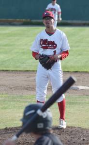 Peninsula Oilers pitcher Austin Merrill checks the sign from his catcher June 8, 2018, against the Anchorage Bucs at Coral Seymour Memorial Ballpark in Kenai. (Photo by Joey Klecka/Peninsula Clarion)