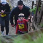 Maddy (559) and John Campbell begin the final ascent up the stairs Saturday at the fourth annual Clam Scramble 5K in Ninilchik. (Photo by Joey Klecka/Peninsula Clarion)