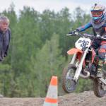 John Mullican, of Soldotna, cheers on his grandson, Draiden, in the 65cc Novice race at the Alaska State Motocross Championships at Twin City Raceway on Sunday, June 17, 2018.