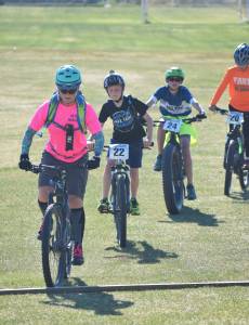 Tsalteshi Sprockets volunteer coach Morgan Aldridge leads a group of youth riders Thursday, June 14, at the Tsalteshi Trails in Soldotna. (Photo by Joey Klecka/Peninsula Clarion)