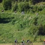Two groups of Tsalteshi Sprockets riders pass by each other Thursday, June 14, at the Tsalteshi Trails in Soldotna. (Photo by Joey Klecka/Peninsula Clarion)
