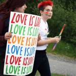 Two marchers celebrate LGBTQ Pride during the Two Spirit march from the Soldotna Sports Complex to Soldotna Creek Park. About 60 people turned out to take part in the march, which was part of wordwide celebrations commemorating the beginning of the LGBTQ civil rights movement. (Photo by Erin Thompson/Peninsula Clarion)