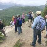 Bill Farrell, a volunteer host at the Kenai National Wildlife Refuge Visitors Center, tells a group about the refuge&rsquo;s history during Take a Hike at the top of the Bear Mountain trail Friday, June 29, 2018. (Photo by Jeff Helminiak/Peninsula Clarion)