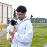 Wildwood Correctional Complex inmate Jonathan Norton holds Vicious Pretty, a Pomeranian rescue being rehabilitated through the Shelter Pet Obedience Training (SPOT) program. The program has taken in and adopted out approximately 85 dogs. (Photo by Erin Thompson/Peninsula Clarion)