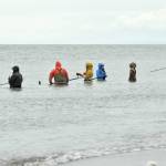 Dipnetters wade into the Cook Inlet in hopes of catching salmon on the first day of dipnetting season on Tuesday, July 10, 2018, in Kenai, Alaska. (Photo by Erin Thompson/Peninsula Clarion)