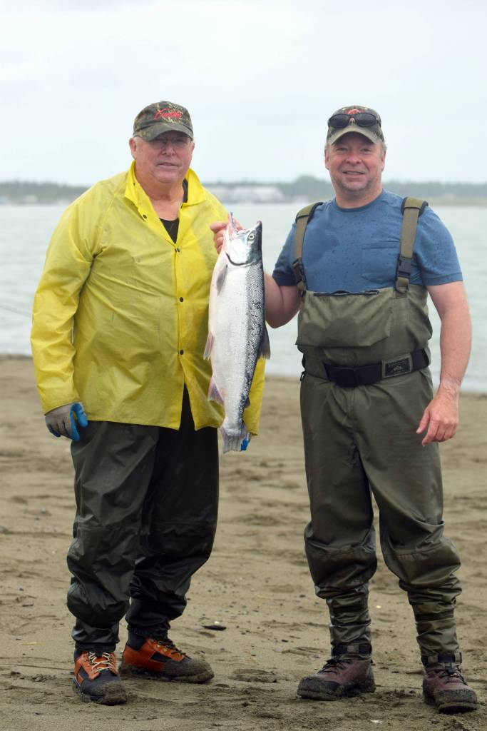 Fred, right, and Bob Kring show off their catch on Kenai Beach on Tuesday, July 10, 2018, in Kenai, Alaska. The two, who regularly travel to Kenai to participate in the dipnetting season, said the fishing had been &ldquo;terrible&rdquo; so far this year. Even so, they had snagged two salmon and a flounder by mid-afternoon Tuesday. (Photo by Erin Thompson/Peninsula Clarion)