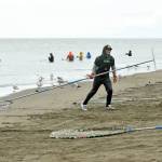 Anchorage resident Colton Herman drags his catch onto Kenai Beach during the opening day of dipnetting season on Tuesday, July 10, 2018, in Kenai, Alaska. Herman has come to Kenai to participate in dipnetting every year since he was a child. He said the catch had been slow so far, but would continue fishing until he got his quota. (Photo by Erin Thompson/Peninsula Clarion)