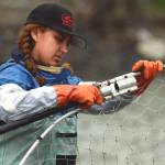 Wasilla resident Alissa Brotherwood preps a dipnet on Kenai Beach during opening day of dipnetting season on Tuesday, July 11, 2018, in Kenai, Alaska. Brotherwood said coming to the dipnetting opening in Kenai is a family tradition. The family smokes and jars salmon caught during the dipnetting season for subsistence. (Photo by Erin Thompson/Peninsula Clarion)