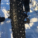 The oversized tires on fat-tire bikes provide traction in soft conditions. Some, like the tire pictured here, include studs for icy trails. (Photo by Will Morrow/Peninsula Clarion)