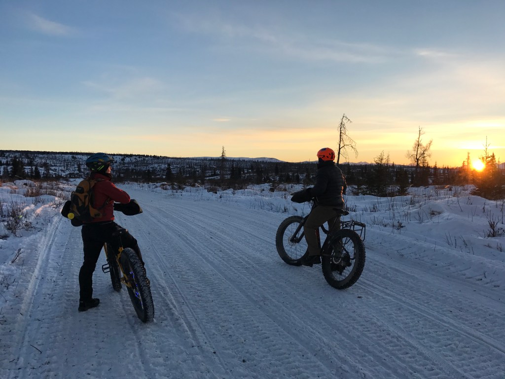 Angie Brennan and Mike Crawford pause to take in the sunrise in the Caribou Hills near Ninilchik on Jan. 8, 2017. (Photo by Will Morrow/Peninsula Clarion)
