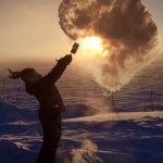 Ice crystals shower down on Courtney Moore Agnes after she flung a pot of boiling water into the air Wednesday, Jan. 18, 2017, in Tanana, Alaska. The temperature Wednesday at the Tanana airport reached 54 below zero Fahrenheit (-48 Celsius), the coldest recorded in the state, and was 5 degrees colder at -59 F (-51 C) along the river. (Cynthia Erickson via AP)