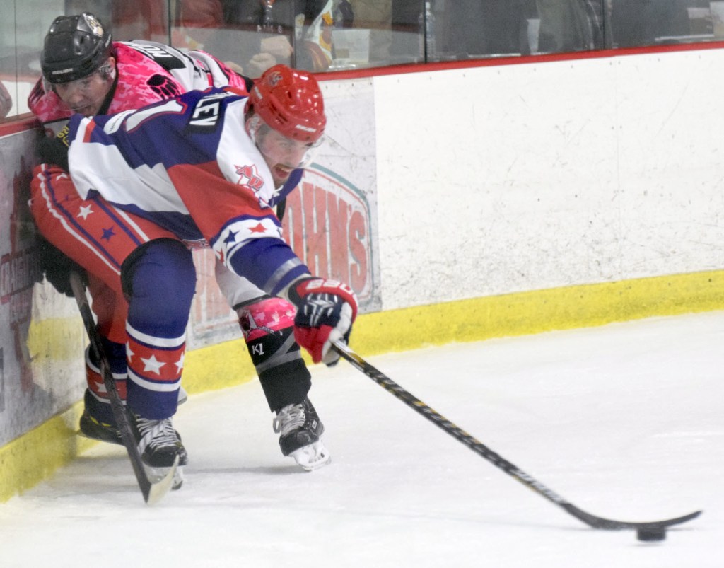 Aston forward Evgeny Takovlev keeps the puck away from Kenai River defenseman Shayne Monahan on Friday at the Soldotna Regional Sports Complex. (Photo by Jeff Helminiak/Peninsula Clarion)
