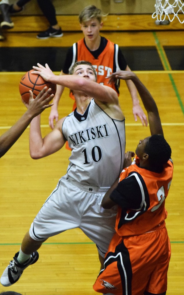 Nikiski forward Ian Johnson (10) puts up a shot against the West JV defense Saturday at Nikiski High School. (Photo by Joey Klecka/Peninsula Clarion)