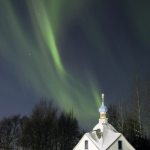 The northern lights illuminate the sky in Old Town Kenai.