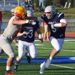 Soldotna junior Hudson Metcalf fends off a tackle by West Valleys Josesph Kimbrough (55) Friday at Justin Maile Field in Soldotna. (Photo by Joey Klecka/Peninsula Clarion)