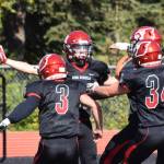 Kenais Zach Burnett celebrates a touchdown with teammates Connor Felchle (3) and Joe Sylvester (34) Saturday against North Pole at Ed Hollier Field in Kenai. (Photo by Joey Klecka/Peninsula Clarion)