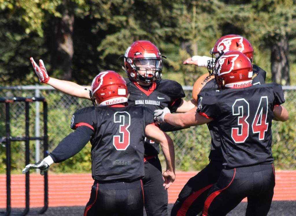 Kenais Zach Burnett celebrates a touchdown with teammates Connor Felchle (3) and Joe Sylvester (34) Saturday against North Pole at Ed Hollier Field in Kenai. (Photo by Joey Klecka/Peninsula Clarion)