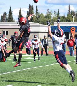 Kenais Braedon Pitsch (88) gets his fingers on a ball intended for North Poles Riley Walters (2) Saturday at Ed Hollier Field in Kenai. (Photo by Joey Klecka/Peninsula Clarion)