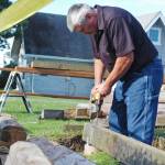Roy Beaver drills a hole through a log as part of a reconstruction of a historic cabin near the bluff in Old Town Kenai on Wednesday, Aug. 29, 2018 in Kenai, Alaska. The cabin, owned by Tim Wisnewski, is one of the original buildings in the Old Town Kenai area and had long since fallen into disrepair before Wisnewski decided to restore it. (Photo by Elizabeth Earl/Peninsula Clarion)