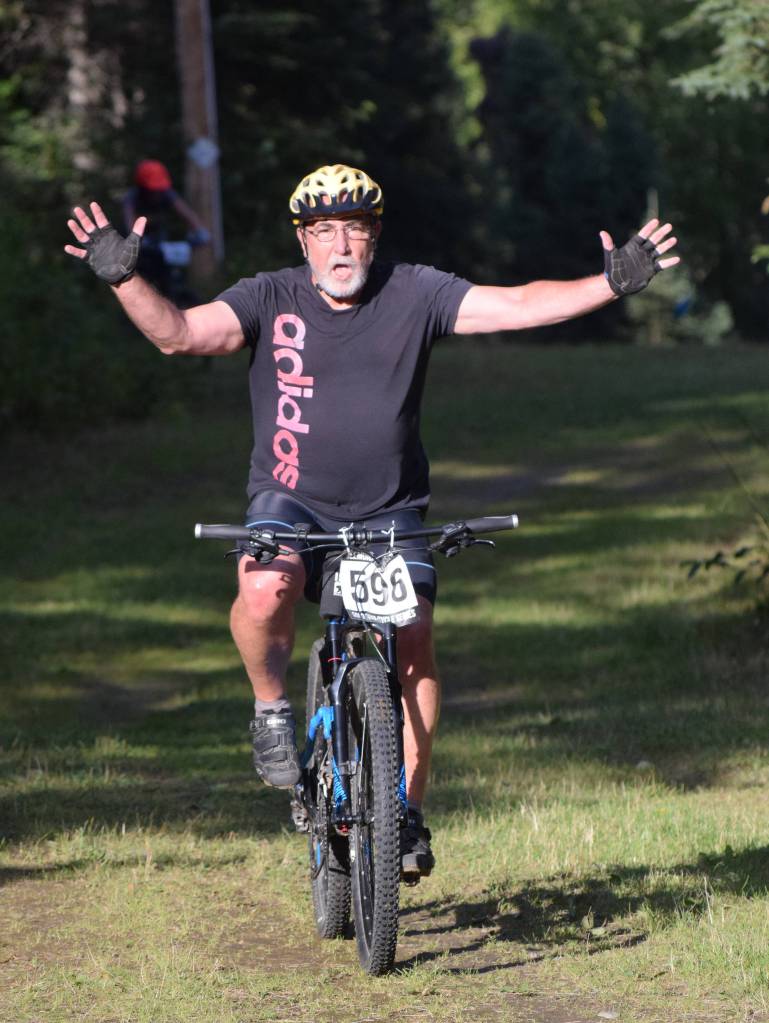 Tony Oliver shows off during his race in the Soldotna Cycle Series season finale held Aug. 30, 2018, at the Tsalteshi Trails. (Photo by Joey Klecka/Peninsula Clarion)