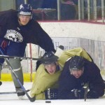 Filip Karlsson of the Brown, Preston Weeks of the Gold and Emils Ezitis of the Brown battle for the puck Friday, Sept. 7, 2018, in the Brown-Gold Game at the Kenai Multi-Purpose Facility. (Photo by Jeff Helminiak/Peninsula Clarion)