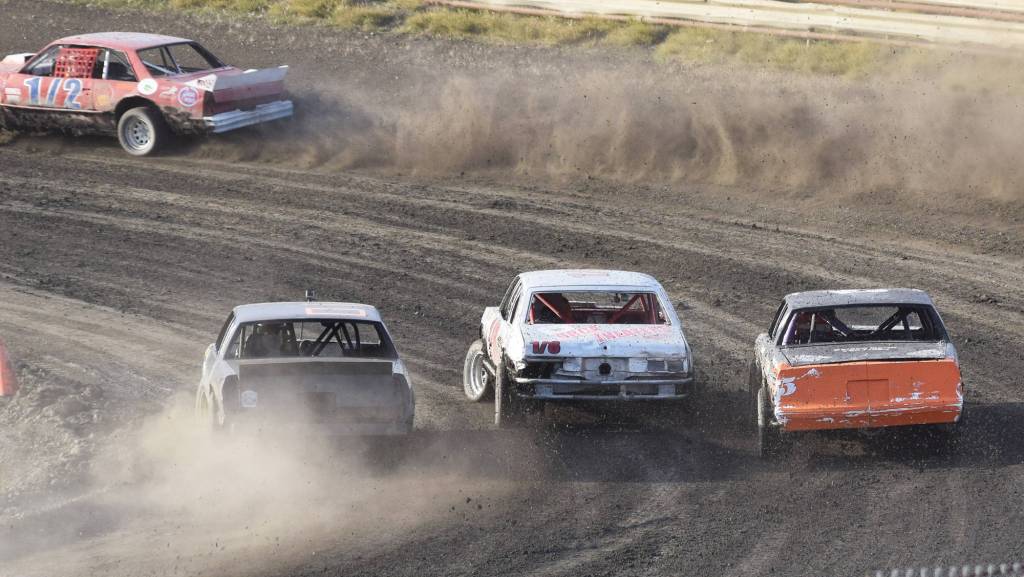 John Clemmons, Chris Endsley and Bridgette Attleson go three abreast into turn 1 Friday night in an A-Stock heat race at Twin City Raceway in Kenai. (Photo by Joey Klecka/Peninsula Clarion)