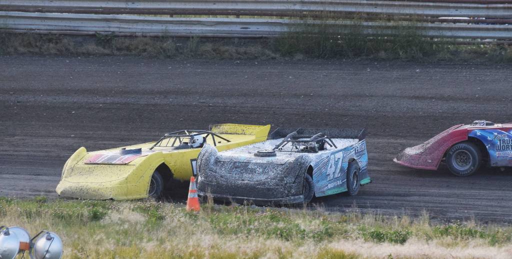 Jon Jenson (left) and Jason Doyle spin out while racing for the lead Friday night in a Late Model heat race at Twin City Raceway in Kenai. (Photo by Joey Klecka/Peninsula Clarion)