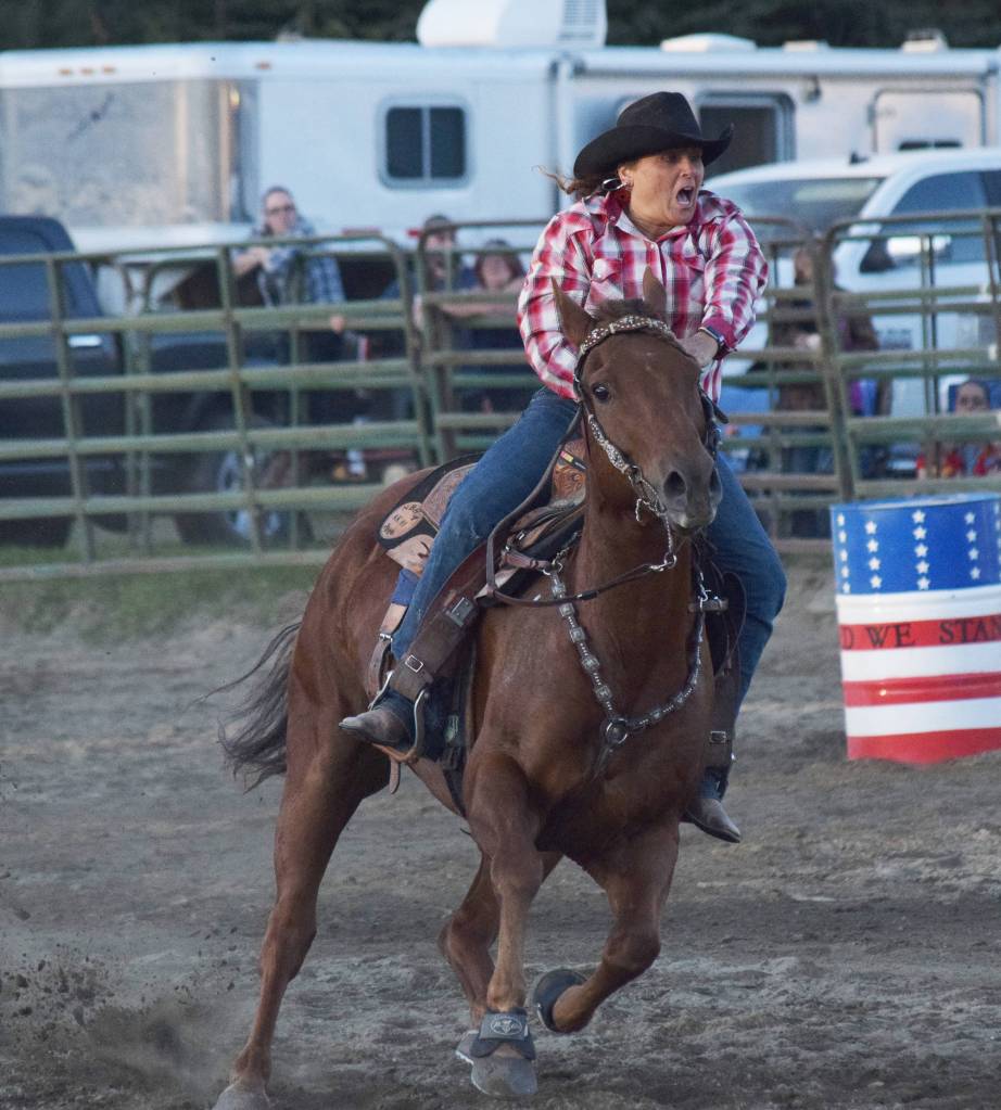 Cassie McKenzie completes a barrel racing circuit Saturday at the 9/11 Tribute Rodeo at the Soldotna Rodeo Grounds. (Photo by Joey Klecka/Peninsula Clarion)