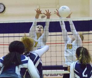 Nikiski teammates and sisters Bethany (10) and Lillian Carstens team up for a block on Soldotnas Bailey Leach, Tuesday at Soldotna High School. (Photo by Joey Klecka/Peninsula Clarion)
