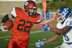 Kenai Centrals Titus Riddall wards off Palmers Morgan Freeman on Friday, Aug. 24, 2018, at Ed Hollier Field in Kenai. (Photo by Jeff Helminiak/Peninsula Clarion)